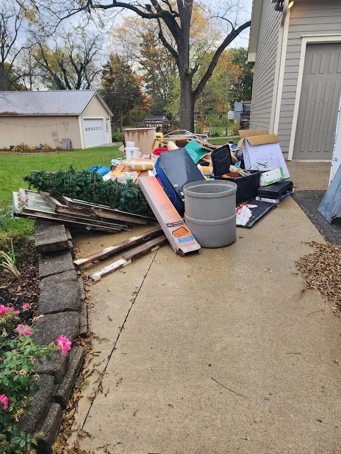 Dumpster being loaded with debris for Roofing Dumpster Rental in Kearns